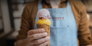 Scrappy's Ice Cream scooper holding ice cream cone lifestyle image by Square 205